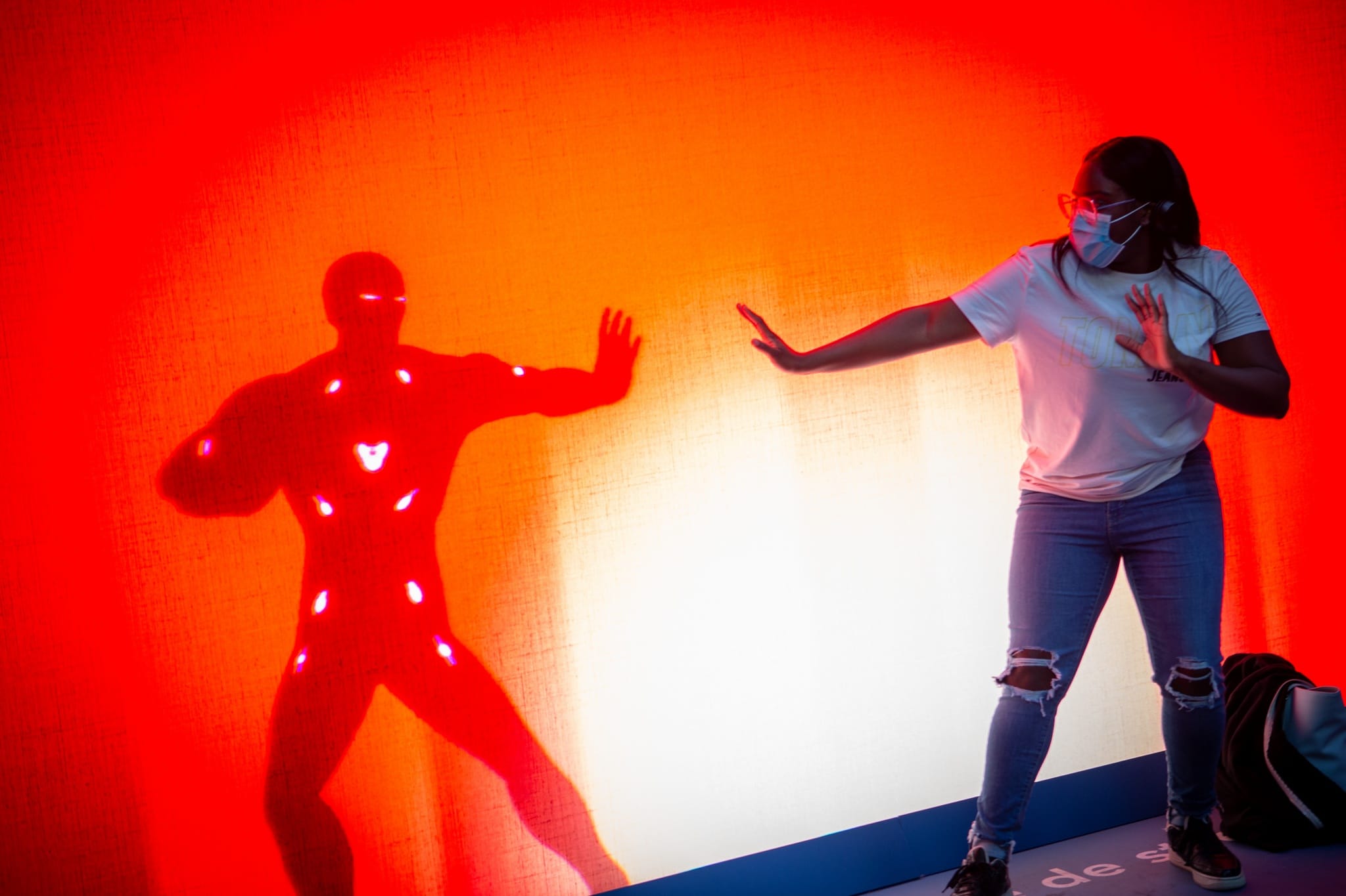 Visitor taking on the Iron Man challenge on the Disney+ shadow wall, Gare Saint-Lazare