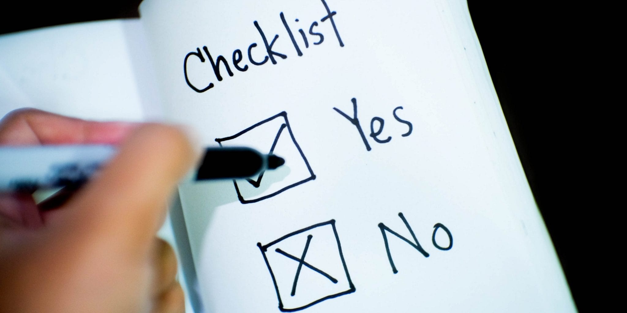 Notebook with a checklist: "Yes" box ticked, "No" box crossed