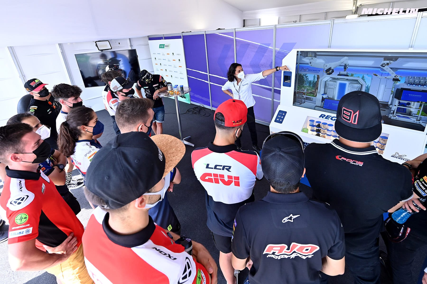 Motorcycle riders listening to the presentation of the Michelin Regen'Lab model