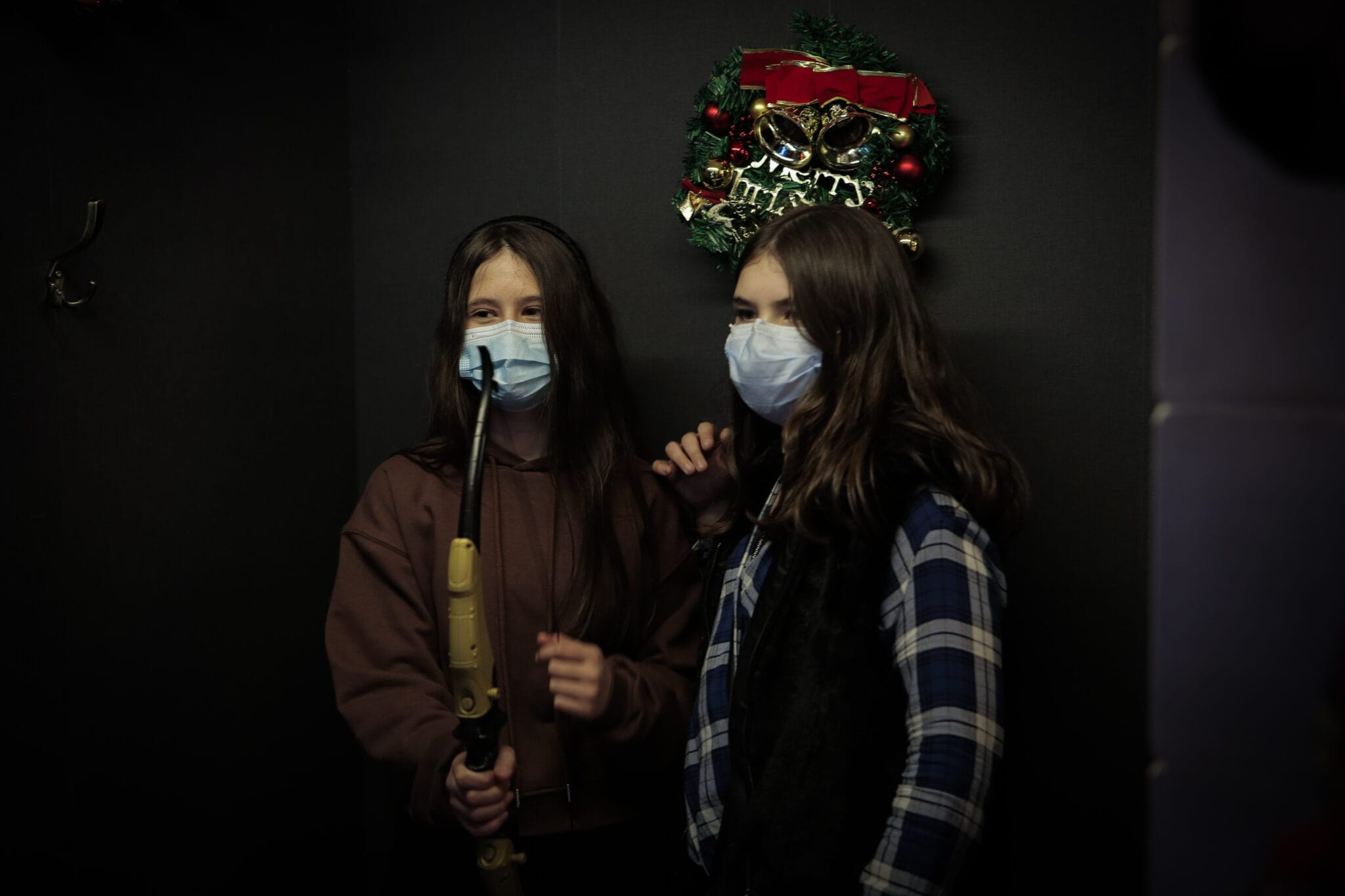 Two young visitors holding a bow in the interactive Hawkeye photobooth