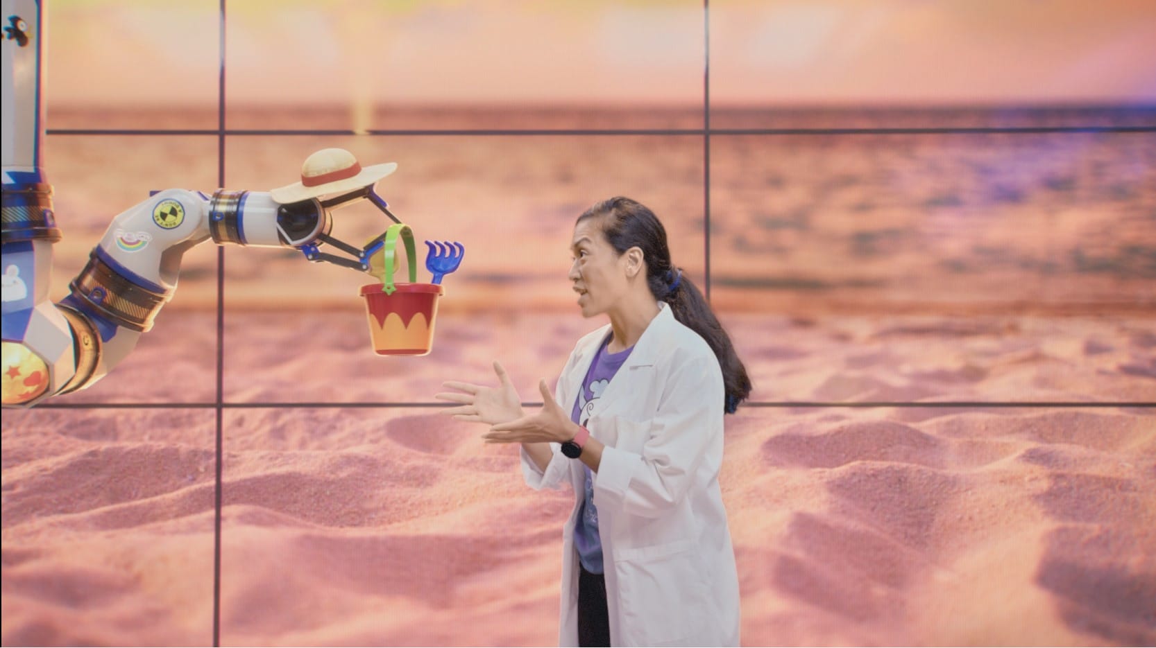 Actress and virtual robot arm on a beach, Michelin series on sustainable materials