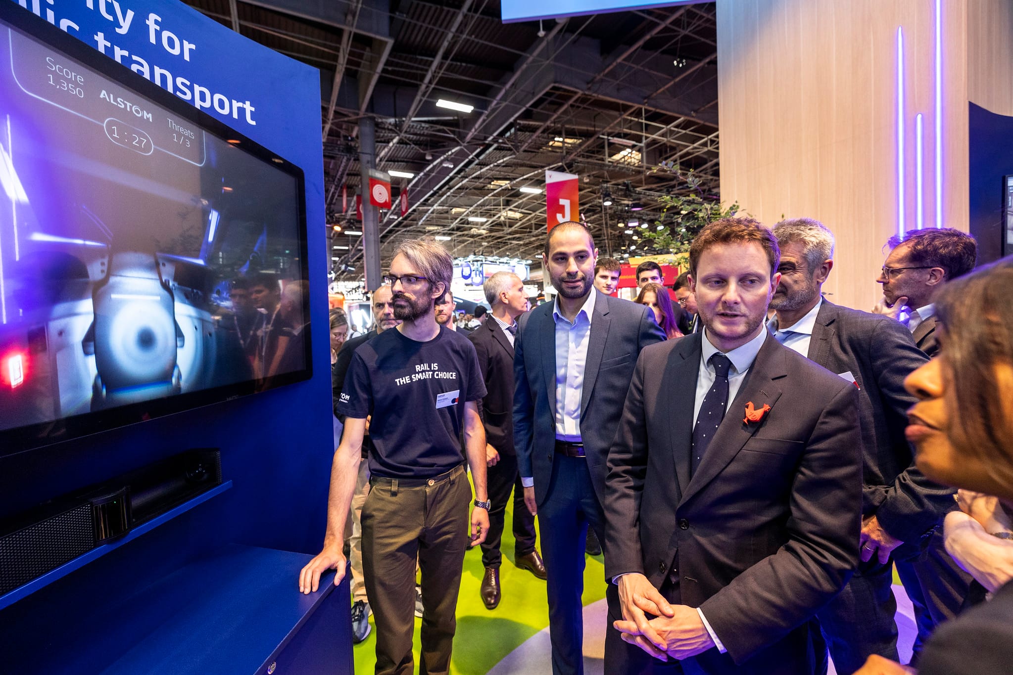 Clément Beaune discovering Alstom's phygital cybersecurity game at VivaTech 2023