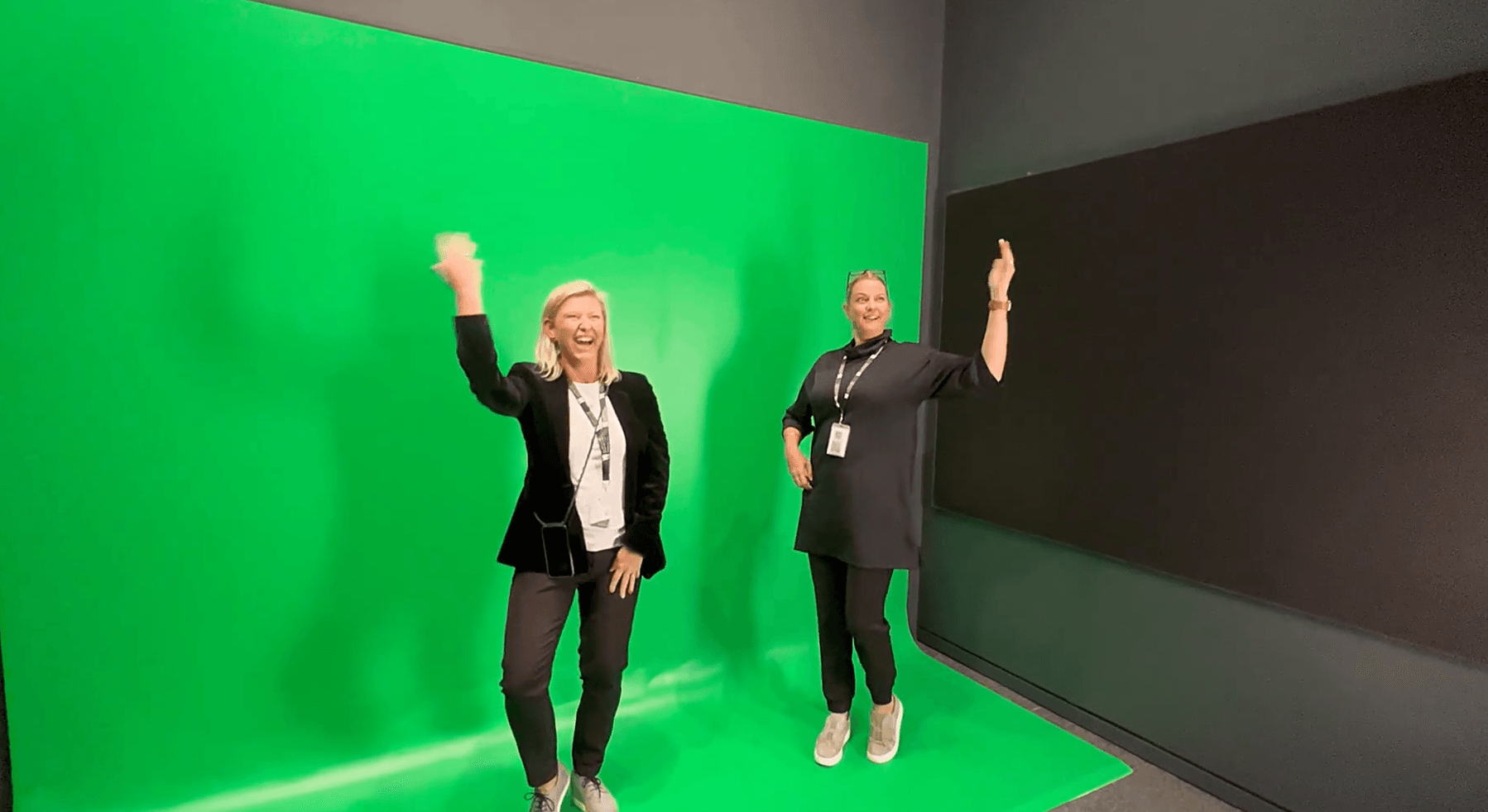 Two visitors dancing on a green screen, Bollywood immersive experience