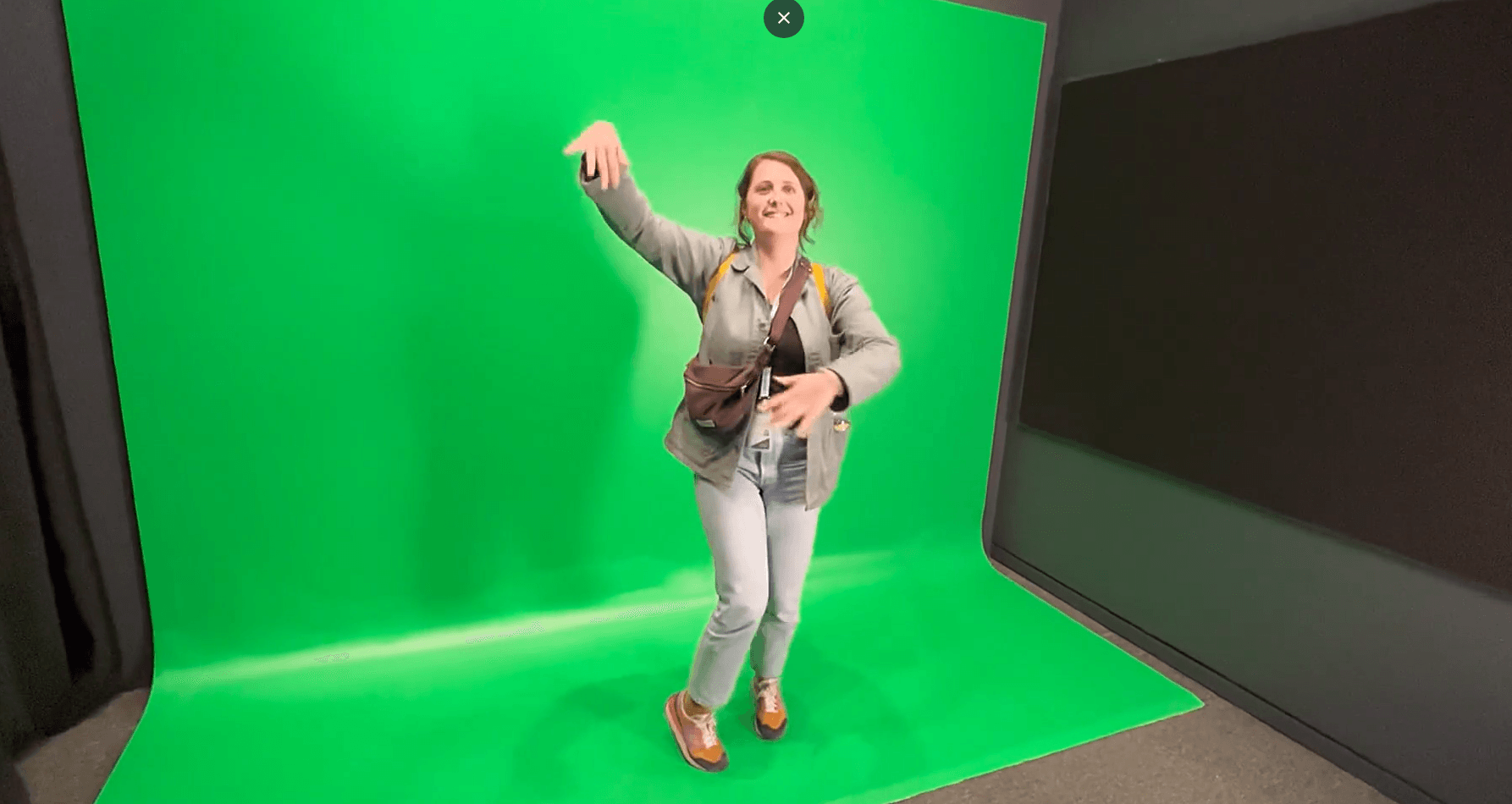 Visitor dancing on a green screen, Bollywood immersive experience at Louvre Abu Dhabi