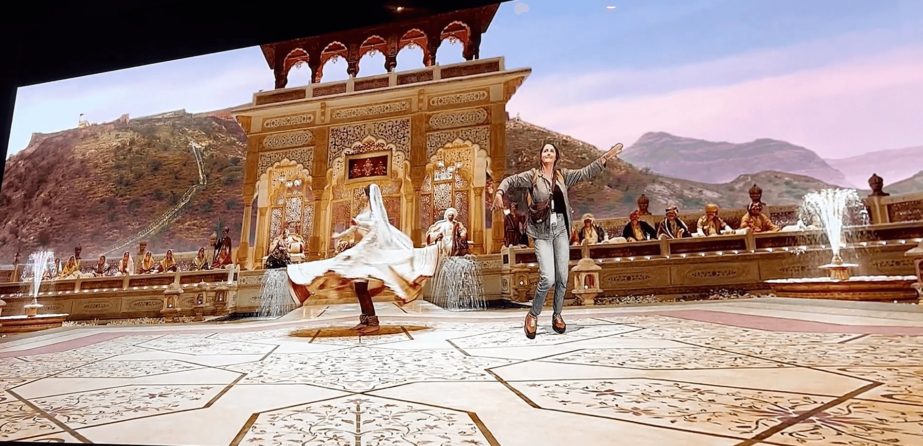 Visitor keyed in dancing with a Bollywood dancer in front of a palace