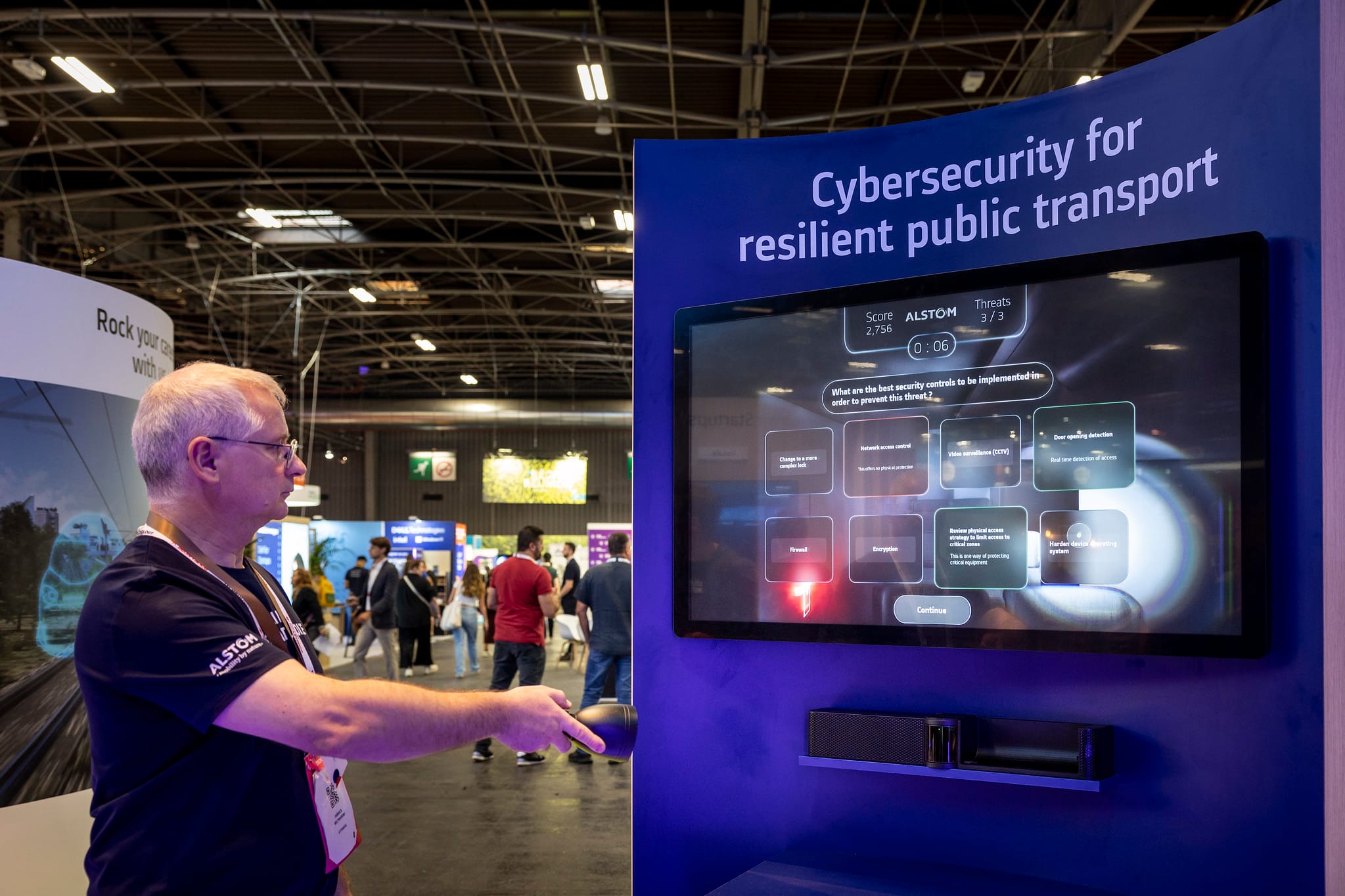 Visitor playing Alstom's cybersecurity serious game on screen at VivaTech
