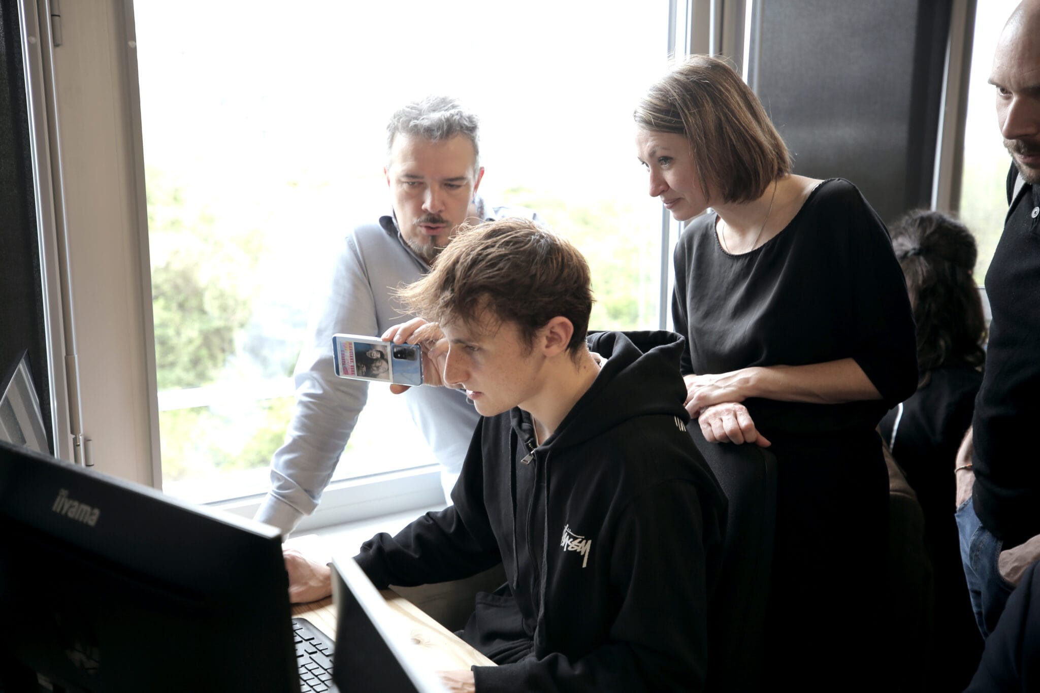 Jury members testing a student's Fortnite game on a computer