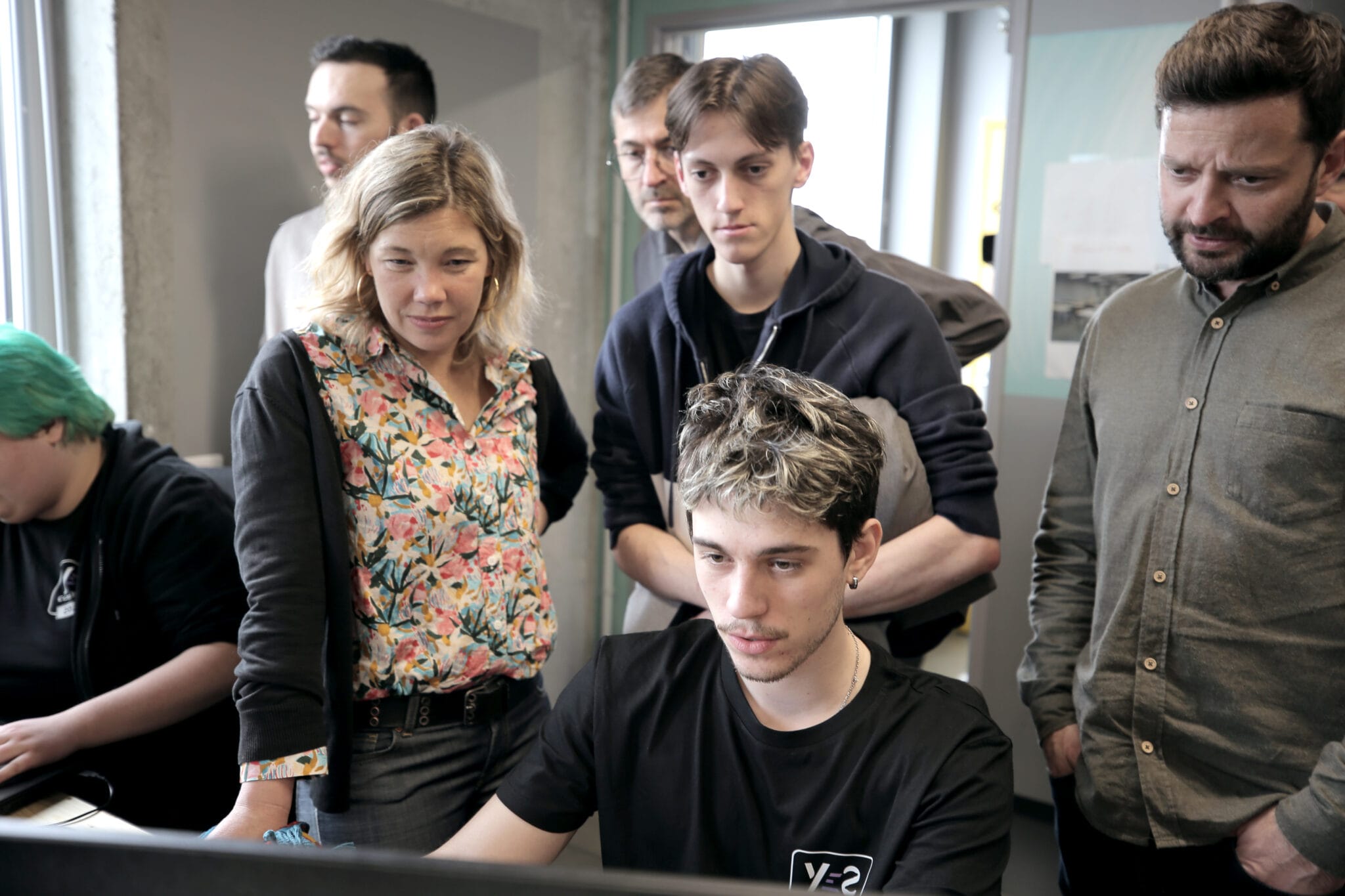 Epic Games and Alstom jury members watching a student present his Fortnite game