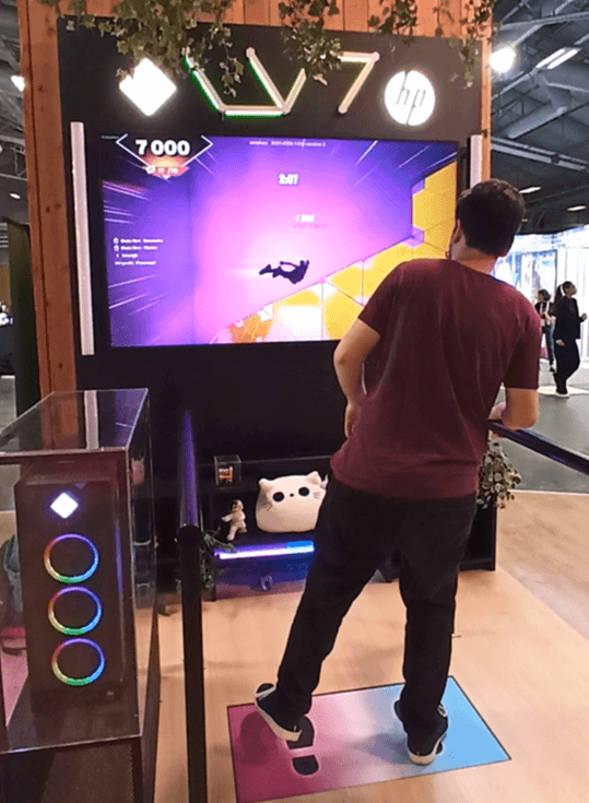 Visitor playing HP's phygital Fortnite game on a connected mat, VivaTech 2024