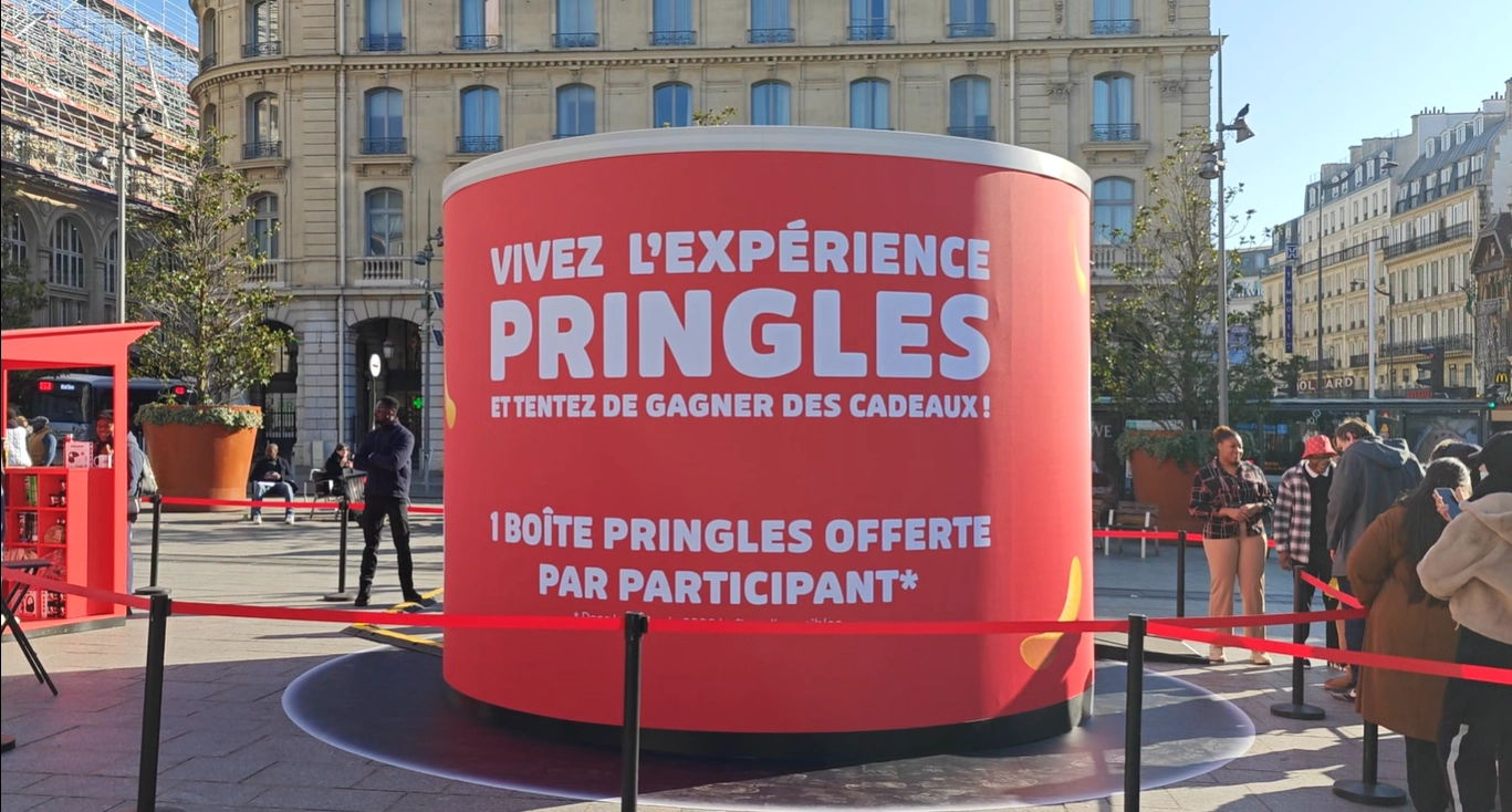 Cylindrical Pringles "Live the experience" stand on a Paris forecourt