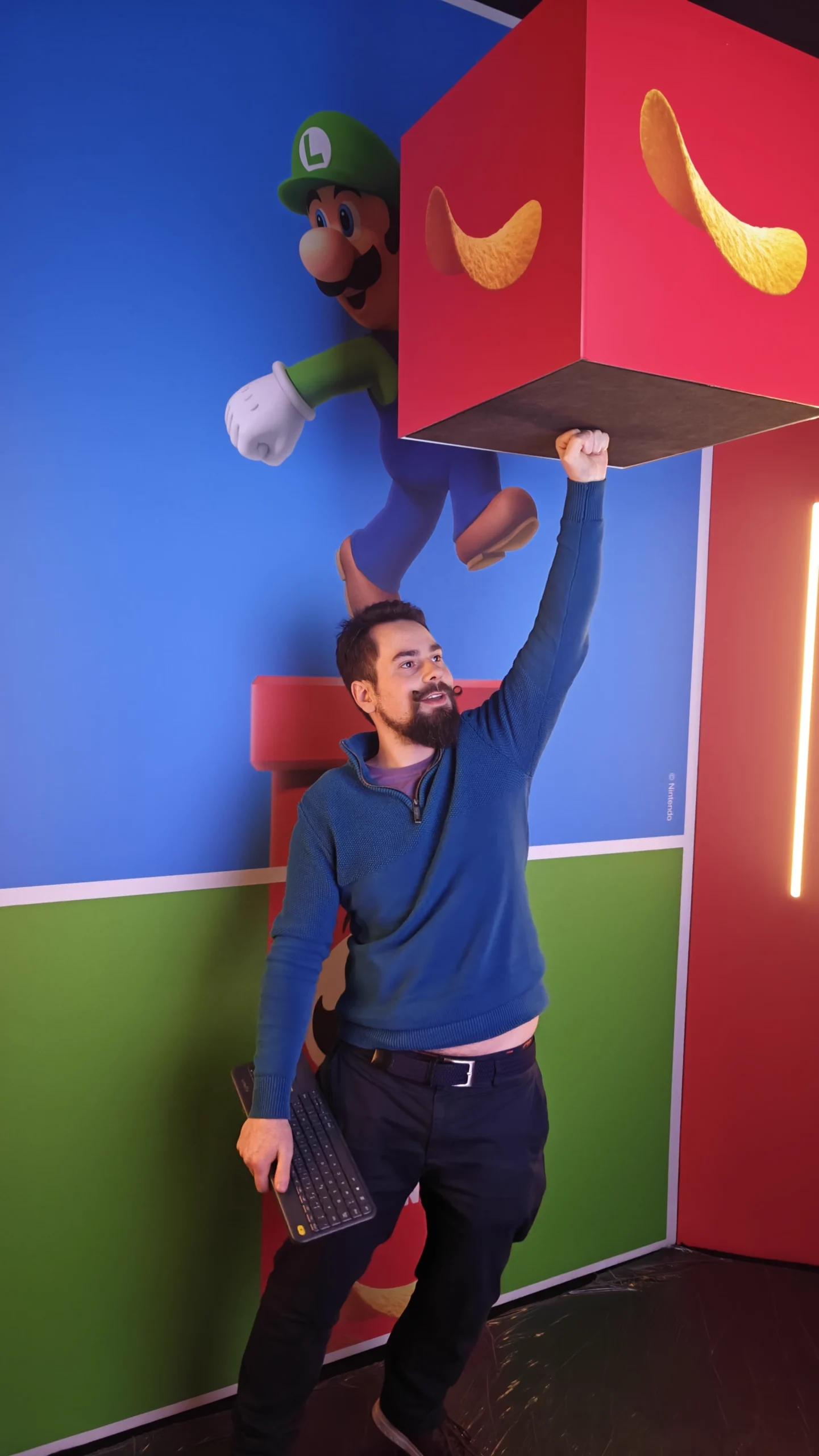 Visitor jumping to hit the Pringles block under Luigi